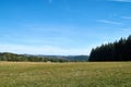 Beautiful landscape in the North Eifel in Germany, with a rye field in the foreground.