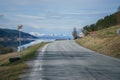 Beautiful landscape with norwegian road near fjord, mountains at background.. Spring in Norway. Royalty Free Stock Photo