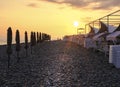 Beautiful landscape of the ocean or sea. Sea beach with straw umbrellas and a number of beach beds. Pebble beach