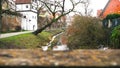 Beautiful landscape with old houses standing along the river banks covered with green plants and bushes. Art. Old town