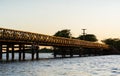 Beautiful landscape with an old iron and wooden bridge and a river during sunset in Colonia Carlos Pellegrini, IberÃÂ¡ Wetlands, Royalty Free Stock Photo