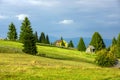 Beautiful landscape with an old wooden cottage on a mountain slope Royalty Free Stock Photo