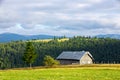Beautiful landscape with an old wooden cottage on a mountain top Royalty Free Stock Photo