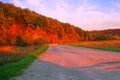 Beautiful landscape. An open paved road leads into the forest. Dirt road in the forest. Travel concept. to green trees with Royalty Free Stock Photo