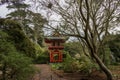 A beautiful landscape with an orange pergola and lush green trees, grass and plants in the Japanese Tea Garden at Golden Gate Park Royalty Free Stock Photo