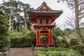 A beautiful landscape with an orange pergola and lush green trees, grass and plants in the Japanese Tea Garden at Golden Gate Park Royalty Free Stock Photo