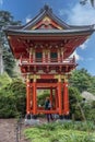 A beautiful landscape with an orange pergola and lush green trees, grass and plants in the Japanese Tea Garden at Golden Gate Park Royalty Free Stock Photo