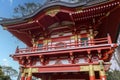 A beautiful landscape with an orange pergola and lush green trees, grass and plants in the Japanese Tea Garden at Golden Gate Park Royalty Free Stock Photo