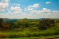 Beautiful landscape overlooking fields and hills with white clouds and blue sky. Brazil