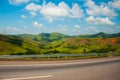 Beautiful landscape overlooking fields and hills with white clouds and blue sky. Brazil