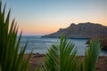 Beautiful landscape with palm leaves, sea and mountains on sunset. Tripiti beach Royalty Free Stock Photo