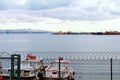 Beautiful landscape photo of harbor with moored fishing boats and ships in Istanbul. Cityscape in the background Royalty Free Stock Photo