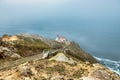 Beautiful landscape, Point Reyes lighthouse on the rocky coast of the Pacific Ocean, a long staircase leads to it Royalty Free Stock Photo