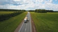 Beautiful landscape with a ride on the highway the trucks and a few cars at sunset. aerial view