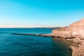 Beautiful landscape of rocky cliff with sea lions during sunset in Valdes Peninsula, Argentina Royalty Free Stock Photo