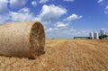 Round Hay Bales on the Field After Harvest Against Blue Sky With White Clouds Royalty Free Stock Photo