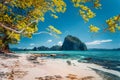 Beautiful landscape scenery of El Nido coastline. Unique amazing Pinagbuyutan island in background framed by tree