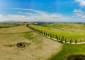 Beautiful landscape scenery of Tuscany in Italy - cypress trees along white road - aerial view -  close to Asciano, Tuscany, Italy Royalty Free Stock Photo