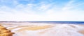 Beautiful landscape scenic view of the beach and water against a cloudy blue sky in summer. Copyspace and banner view of Royalty Free Stock Photo
