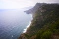 Sea and cliffs, pink lilly flowers and waterfall in Quinta do Furao, Santana, Madeira, Portugal