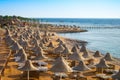 Beautiful landscape of the sea coast in the tropics. There are many of sun umbrellas and deck chairs on the beach. View of the Royalty Free Stock Photo