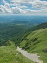 Beautiful landscape seen from top of the green mountain in summer season. horizon line on sunny day with blue sky and fluffy cloud Royalty Free Stock Photo