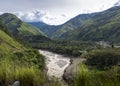 Beautiful landscape shot of scenery with a river, green hills and clouds Royalty Free Stock Photo