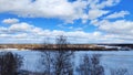 Beautiful landscape with sky, clouds and a river with ice on a sunny spring day Royalty Free Stock Photo