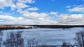 Beautiful landscape with sky, clouds and a river with ice on a sunny spring day Royalty Free Stock Photo