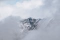 Beautiful landscape of snow lofty Austrian Mountain in clouds