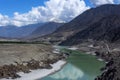 beautiful landscape of snow mountains with green river blue sky and white clouds