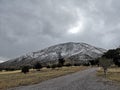 Beautiful landscape with a snowing road and a wonderful mountain Royalty Free Stock Photo