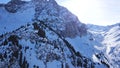 Beautiful landscape of snowy mountains. The view of the gorge and forest.