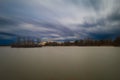 Beautiful landscape before the storm. Bird island in the middle of the pond. Dramatic clouds