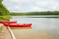 Canada forest park nature with red kayaks canoe boats by water