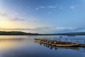 Beautiful landscape sunrise over still lake with boats on jetty Royalty Free Stock Photo