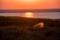 Beautiful landscape with sunset over saline lake Baskunchak and feather grass