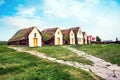 Beautiful landscape with traditional wooden houses with moss-covered roofs and church in Pioneer Museum in Glaumbaer, Iceland.