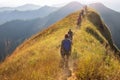 Beautiful landscape with trekkers walking on mountain ridge in sunset at Khao Chang Phuak, Thong Pha Phum National Park, Royalty Free Stock Photo