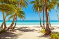 Beautiful landscape of tropical beach on Boracay island, Philippines. Coconut palm trees, sea, sailboat and white sand. Nature Royalty Free Stock Photo