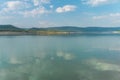 Beautiful landscape with turquoise lake, reflection of blue sky and wild mountains. Relaxing paradise background. Tranquility.