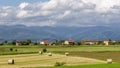 Beautiful landscape of the Tuscan countryside between the provinces of Pisa, and Lucca with hay bales in the foreground