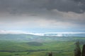 Tuscany, rural landscape. Countryside farm, cypresses trees, green field, cloudy day Royalty Free Stock Photo