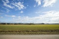 Beautiful landscape view with fields, forest trees and blue sky with white clouds. Royalty Free Stock Photo