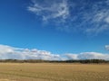 Beautiful landscape view with fields, forest trees and blue sky with white clouds. Gorgeous spring backgrounds. Royalty Free Stock Photo