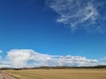 Beautiful landscape view with fields, forest trees and blue sky with white clouds. Gorgeous spring backgrounds. Royalty Free Stock Photo