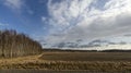 Beautiful landscape view with fields, forest trees and blue sky with white clouds. Gorgeous spring backgrounds. Royalty Free Stock Photo