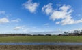 Beautiful landscape view with fields, forest trees and blue sky with white clouds. Gorgeous spring backgrounds. Royalty Free Stock Photo