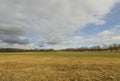 Beautiful landscape view with fields, forest trees and blue sky with white clouds. Gorgeous spring backgrounds. Royalty Free Stock Photo