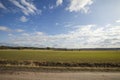 Beautiful landscape view with fields, forest trees and blue sky with white clouds. Gorgeous spring backgrounds. Royalty Free Stock Photo